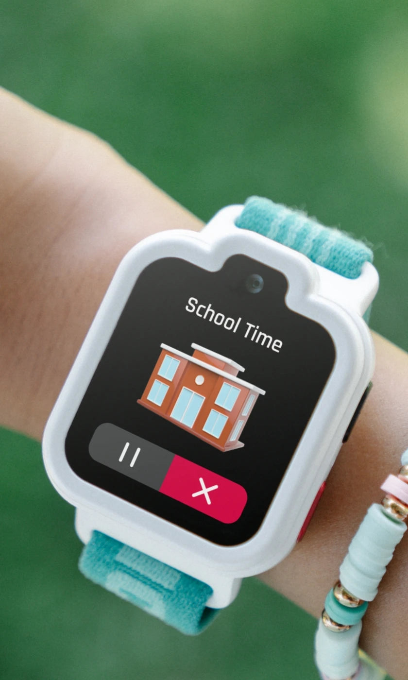 White TickTalk 6 smartwatch displaying a School Time reminder