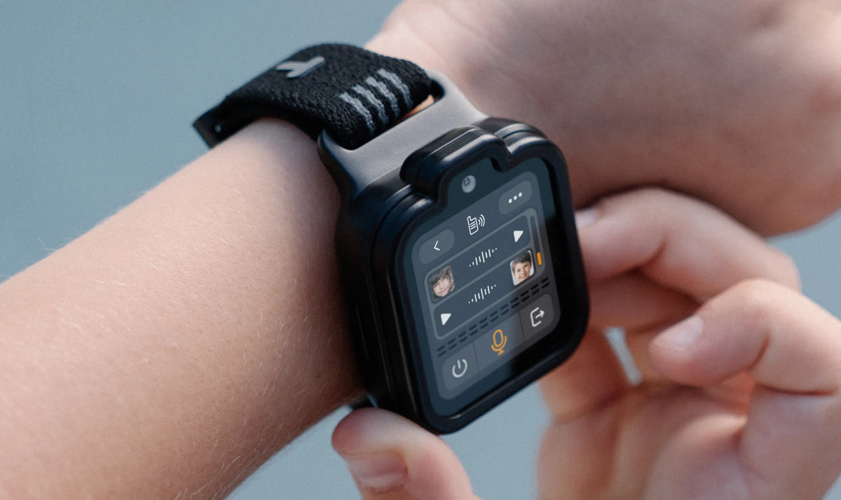 Child using TickTalkie push-to-talk on a black TickTalk 6 kids smartwatch.