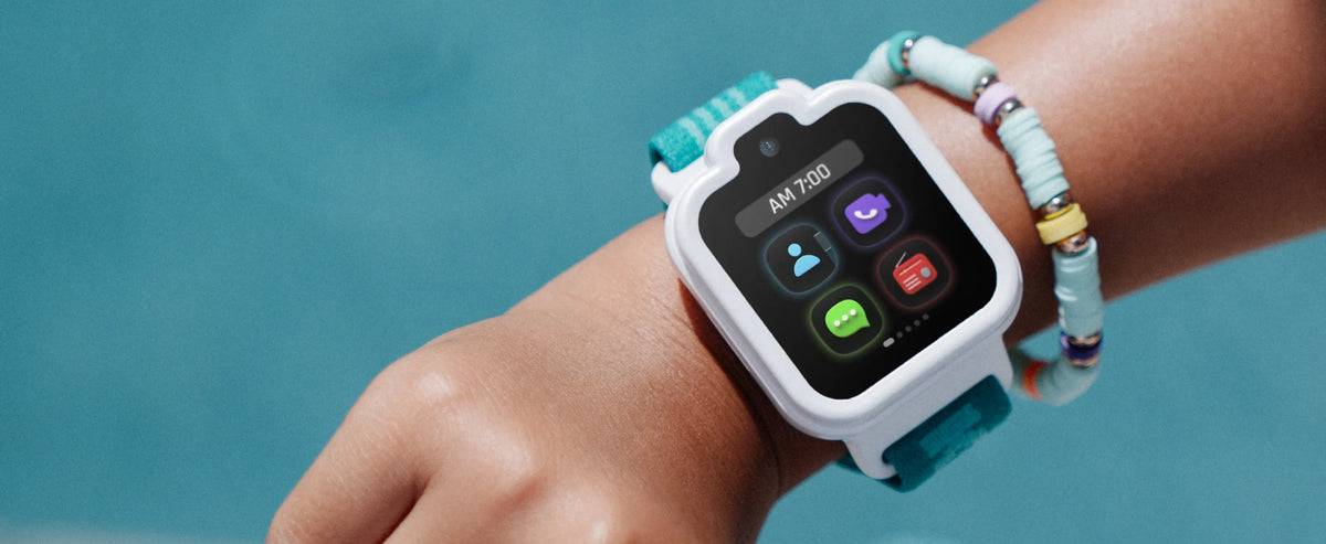 White TickTalk 6 kids smartwatch with a teal band worn on a wrist