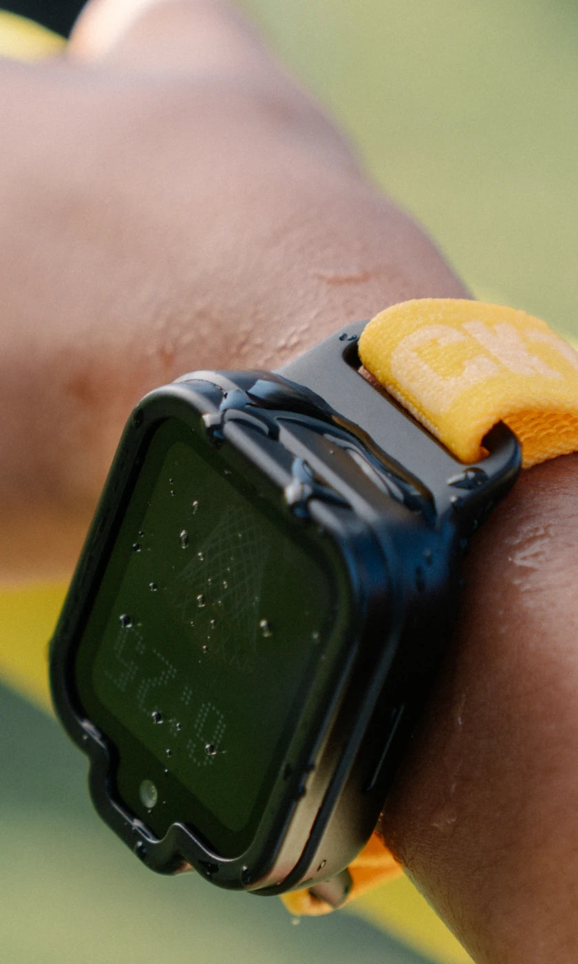 Black TickTalk 6 smartwatch with water droplets on its case and screen