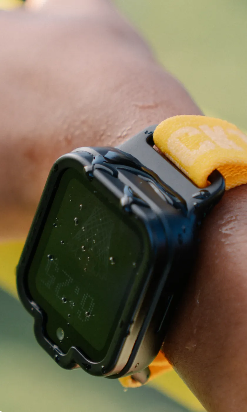 Black TickTalk 6 kids smartwatch with water droplets on its water-resistant case and screen.